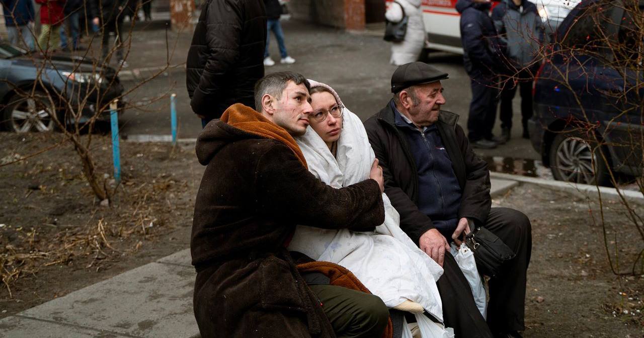 Мужчина и женщина смотрят, как пожарные тушат пожар в их доме, пострадавшем от попадания обломков российской ракеты. Киев, 7 февраля 2024 года / Фото Суспільне