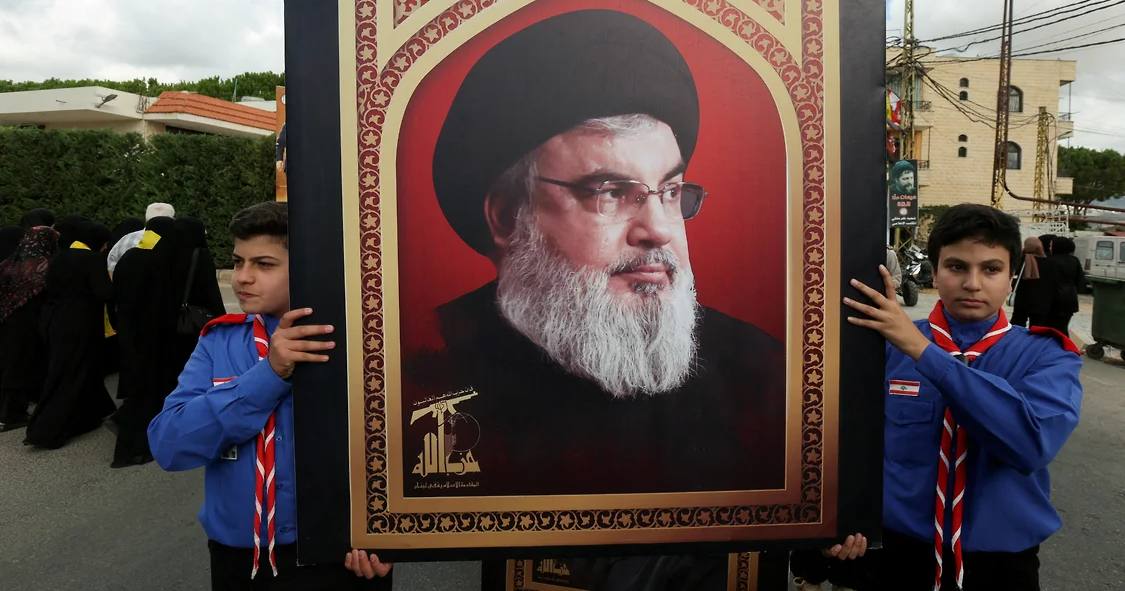 Хлопчики-скаути несуть фотографію лідера «Хезболли» Сайєда Хасана Насралли під час похорону члена «Хезболли» Алі Мохамеда Чалбі в Кфар Мелкі, Ліван, 19 вересня 2024 року / Фото Reuters