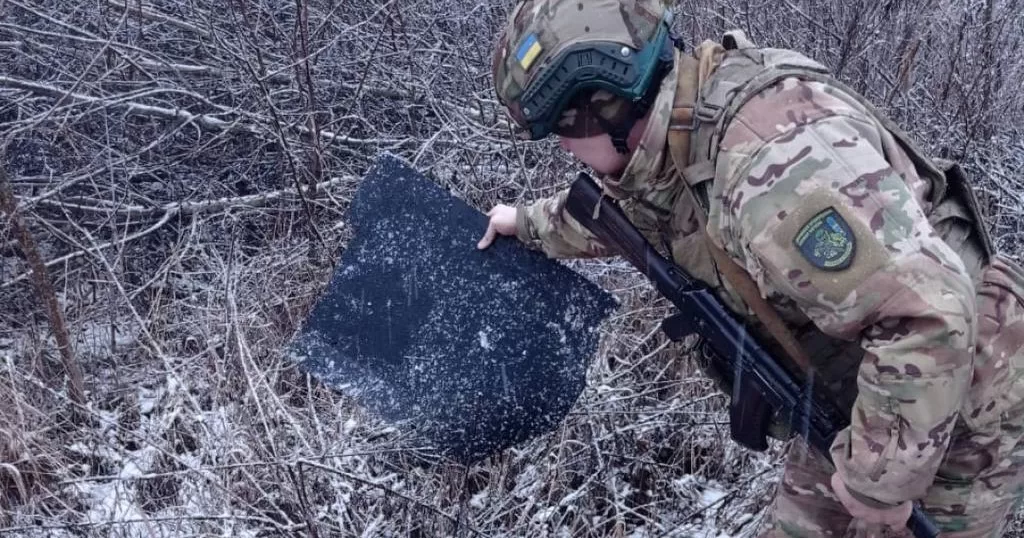 A border guard holds a piece of a UAV shot down in Sumy region / Photo by the State Border Guard Service of Ukraine