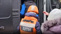 Дитина сідає в евакуаційний транспорт / Скриншот з відео