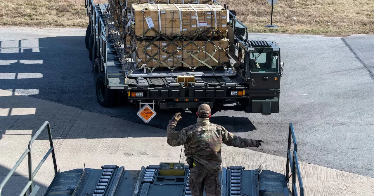 Air Force Senior Airman Cameron Manson, 436th Aerial Port Squadron ramp operation specialist, marshals a K-loader of cargo during a Ukraine security assistance mission at Dover Air Force Base, Del., Feb. 3, 2023 / Photo Air Force Senior Airman Faith Barron