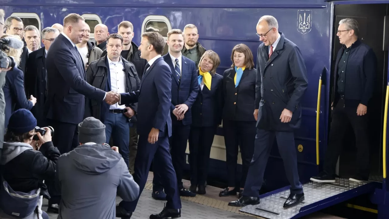 Официальный представитель приветствует Эммануэля Макрона, Фридриха Мерца и Кира Стармера после их прибытия на Киевский вокзал 10 мая / Фото AFP