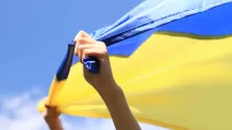 A woman holds a Ukrainian flag / Stock photo: DepositPhotos